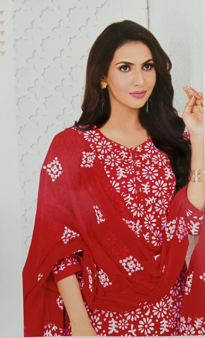 Woman wearing a red and white floral dress against a light background